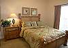 Third bedroom with queen size bed and an adjoining bath with tile shower