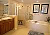 Master bath with whirlpool tub, tile shower, water closet and double vanities.