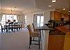 Spacious dining table for 6 and 2 barstools at the counter.