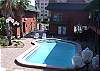 View of the tropical courtyard pool from the entrance to 210.  The beach is right behind the building across the street.
