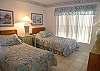 Guest bedroom with twin beds 
and adjacent bath.