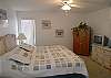 Master bedroom with king size bed, cable TV and adjoining bath with tile shower.
