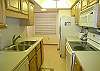 The kitchen has a side by side refrigerator, stove/oven, diswasher, disposal, microwave & washer/dryer.