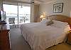 Master Bedroom with king size bed, sliding doors to the bayfront balcony, 32 inch flatscreen TV with DVD & walk-in closet.