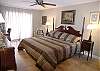 Master bedroom with king size bed, Gulf front balcony, cable TV/VCR and desk with high-speed internet modem.