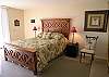Bedroom with queen size bed, adjoining bath with tub/shower, walk-in closet, cable TV and sliding doors to the balcony.