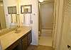 Master bath with tub/shower and separate vanity area.