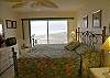 Master bedroom with sliding doors to the balcony, king size bed, cable TV and adjoining bath with shower.