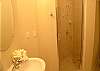 Third bathroom with tile shower.