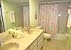 Master bath with double vanity and tub/shower.