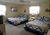 Guest bedroom with one queen size bed, one double bed, cable TV, walk-in closet and an adjoining bath.