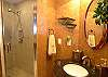 Third bathroom with tile shower.