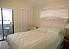 Master bedroom with queen size bed, cable TV, vaulted ceiling and sliding doors to the Gulf view balcony.