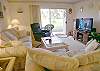 Living room with new Flatscreen TV, comfortable recliner & sliding glass doors to the patio.