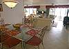 Open living/dining area with new tile floors.
