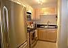 Kitchen with granite counters & stainless steel appliances.