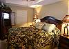 Third bedroom with queen size bed, 24" LCD TV and a nearby full bath with tile shower.