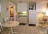 Compact kitchen & full size refrigerator.