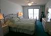 Master bedroom sliding glass doors to the Gulf front balcony.