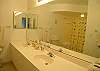 Master bathroom with double vanity and large tub/shower.