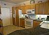 The counter tops are granite, it has a smooth top stove, plenty of cupboards with matching refrigerator front and pantry with washer and dryer.