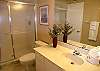 Guest bath with large vanity & tile shower.