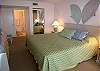 Master bedroom with adjoining bath with tub/shower and large vanity.