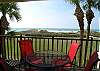 Great Gulf Front balcony with a table and chairs for dining or watching the dolphins play!