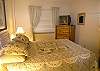 Third bedroom with queen size bed and TV.