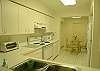 Kitchen with breakfast area and laundry room at the end.