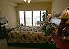 Gulf front master bedroom with sliding doors to the balcony, king size bed, LCD TV and adjoining bath with oversized tub & separate shower.