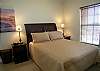 Queen size bed, walk-in closet and adjoining bath with tile shower.