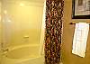 Master bath with oversized soaking tub with shower.