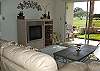 New comfortable leather living room with private patio and golf course view.  There is a queen size sofa bed, cable tv, vcr and stereo.