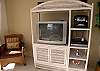 Entertainment center with  TV/DVD, stereo, wireless internet and telephone with answering machine.