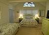 Guest bedroom with one queen size bed, one twin bed, cable TV/DVD and adjoining bath with shower.