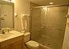 Third bathroom with tile shower.