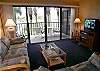 Living room with cable TV/VCR and balcony with bay view.