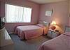 Twin beds in the guest room, cable TV and an adjacent bath with tile shower.