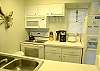 The bright, white kitchen has all new appliances and a walk-in pantry.