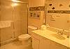 Guest bathroom with tile shower.