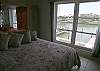 Master bedroom with beautiful view of the bay from the queen size bed.