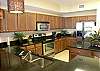 Huge kitchen with granite countertops and stainless steel appliances.