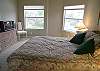 Master bedroom with vaulted ceilings, queen size bed, cable TV, walk-in closet and adjoining bath.