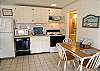 The kitchen includes a dishwasher, as well as a refrigerator, microwave and stove.