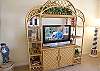 Flatscreen cable TV and stereo CD.