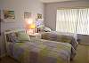 The guest bedroom has two twin size beds, a walk-in closet, cable TV and adjoining bath with tile shower.