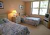 Guest bedroom with twin beds, TV/DVD (no cable) and an adjoining bath with tile shower.