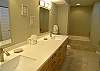 Totally remodeled master bath!  Beautiful tile floors, double vanity with solid surface counter, undermount sinks & luxurious soaking tub.