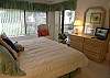 Master Bedroom with flatscreen TV &amp; doors to the screened patio